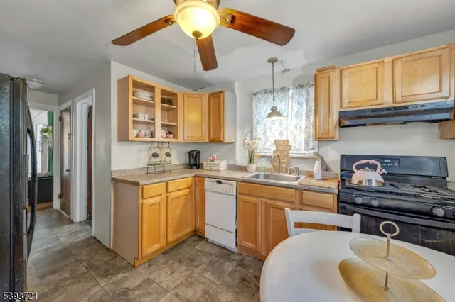 a kitchen with stainless steel appliances granite countertop a sink a stove and a refrigerator