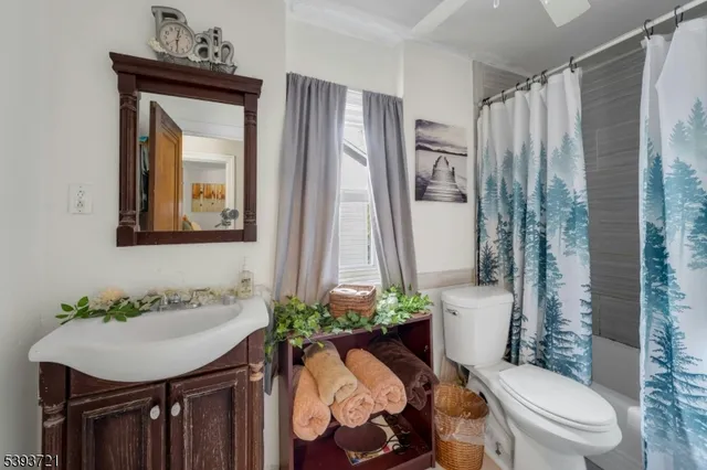 a bathroom with a toilet a sink and a mirror