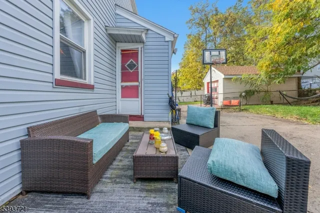 a sitting area with furniture and wooden fence