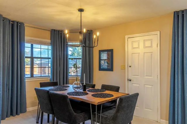 a view of a dining room with furniture window and outside view