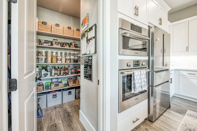 a living room with furniture a fireplace and a floor to ceiling window