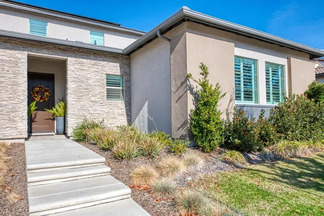 a view of the house with potted plants