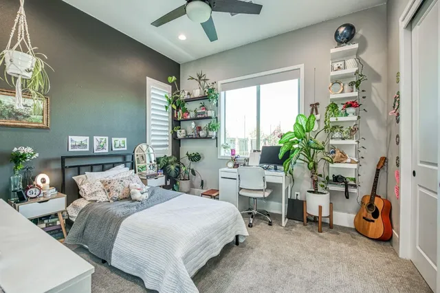 a bed room with a bed window and a chair