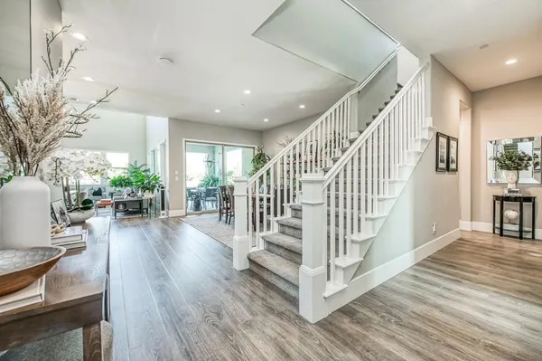 a living room with furniture a fireplace and a floor to ceiling window