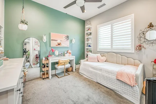 a living room with patio furniture and a potted plant