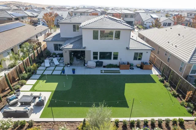 an aerial view of a house with garden space swimming pool and outdoor seating