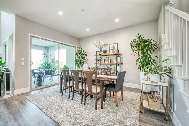 a dining room with furniture and wooden floor
