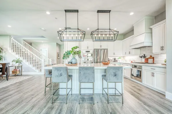 a kitchen with a sink a stove cabinets and a window