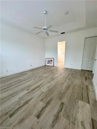 an empty room with wooden floor and stairs