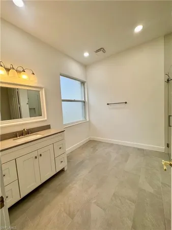 a spacious bathroom with a double vanity sink and a mirror
