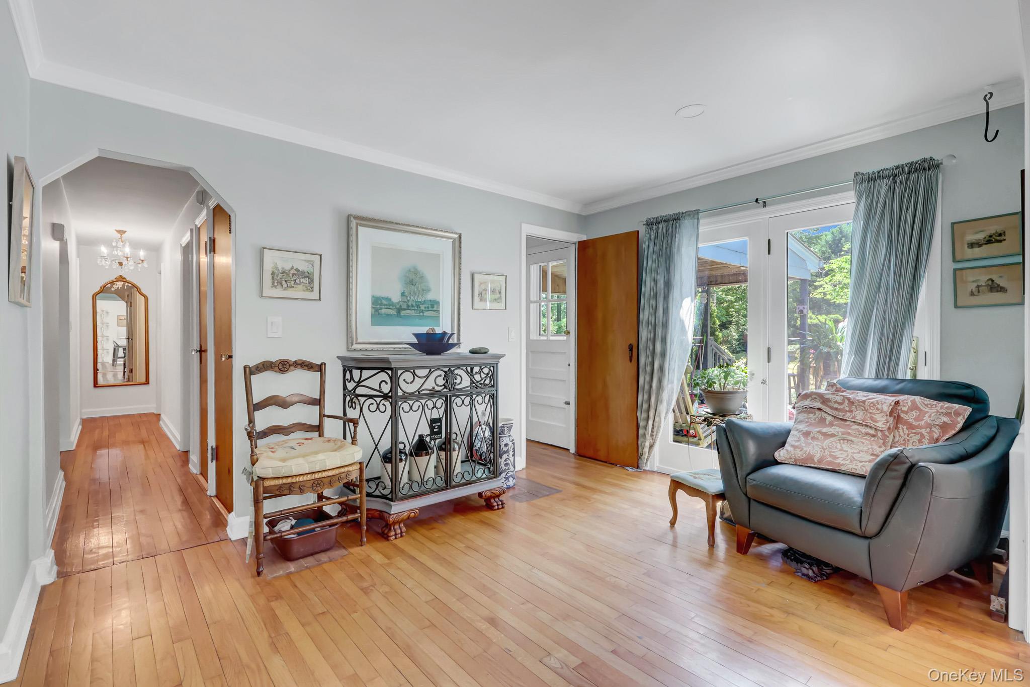 100 Elwood Road Northport, NY 11768 - Photo 13 of 39 Hardwood flooring throughout, leading to an arched doorway