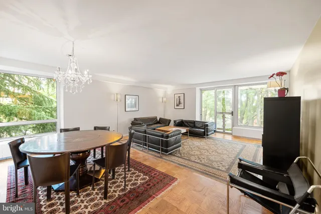 a view of ocean with boats and trees in the background