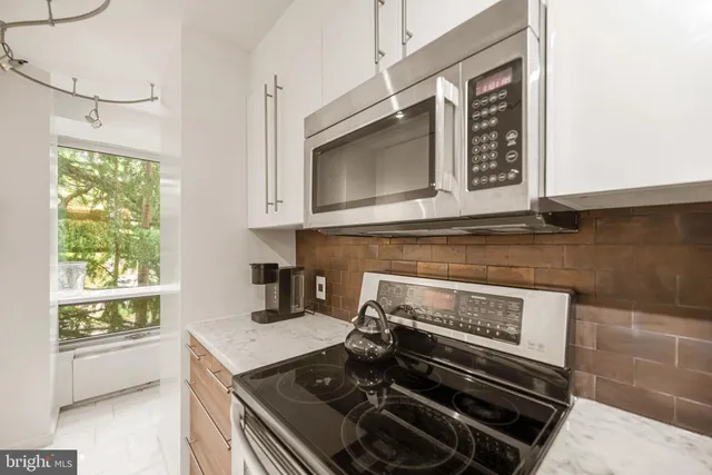 a view of a dining room with furniture and a chandelier