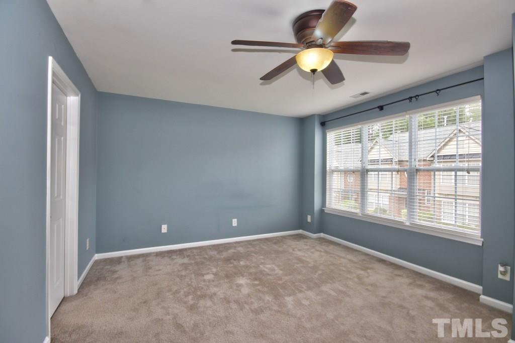 9904 Grettle Court Raleigh, NC 27617 - Photo 12 of 22 Large closet and a ceiling fan along with the carpeting