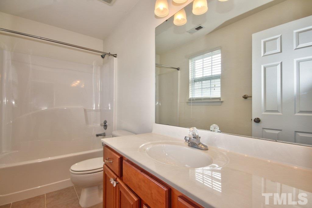 9904 Grettle Court Raleigh, NC 27617 - Photo 17 of 22 Additional large bathroom includes tile flooring and a tub/shower.