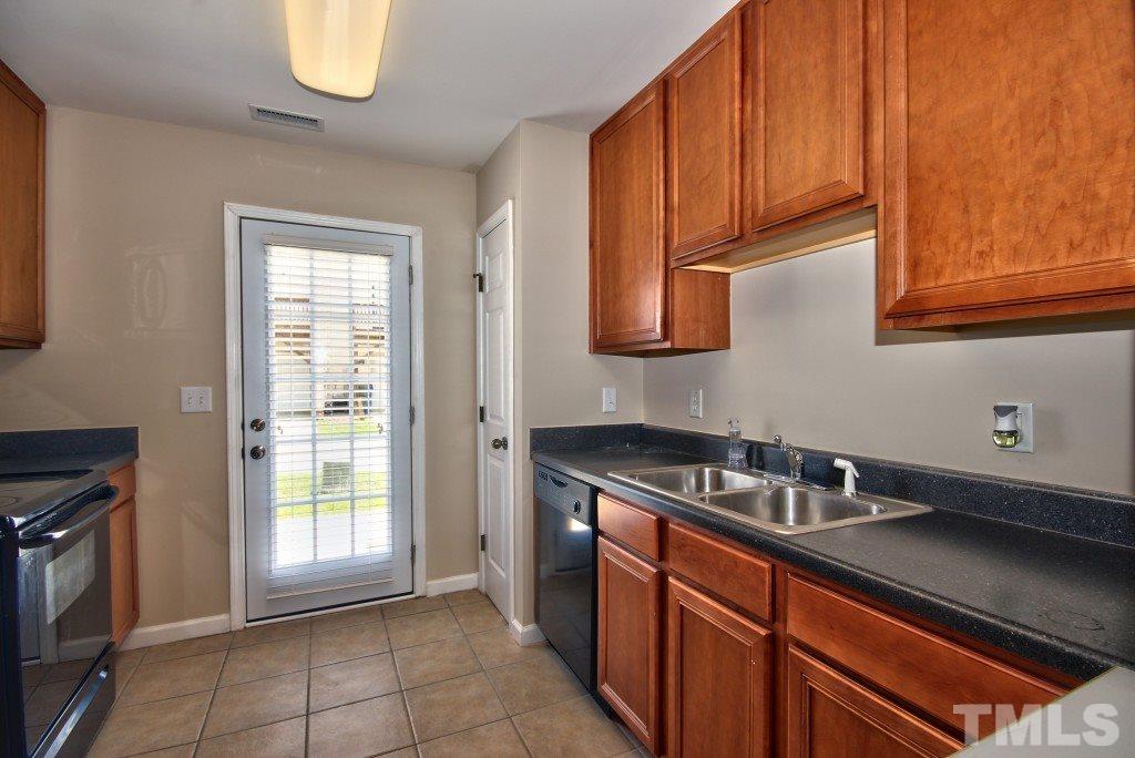 9904 Grettle Court Raleigh, NC 27617 - Photo 8 of 22 Lots of cabinetry and a pantry for storage in your new kitchen!