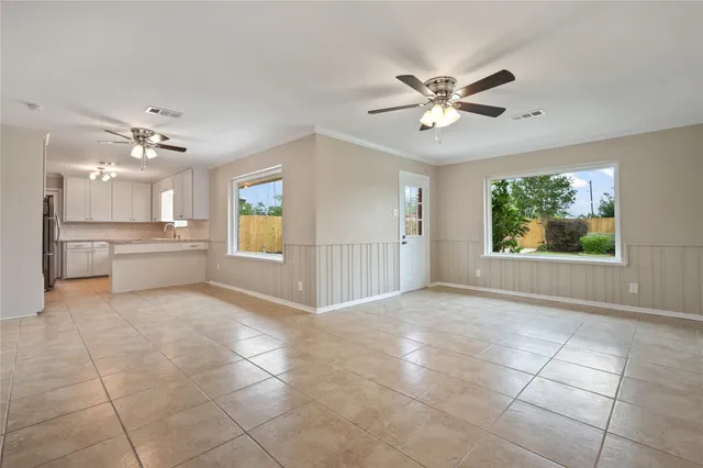 a view of a livingroom with a ceiling fan and window