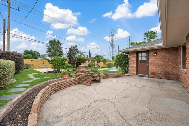 a view of a house with a yard and potted plants