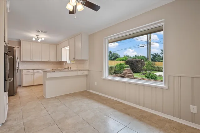 a kitchen with a stove a refrigerator and a sink