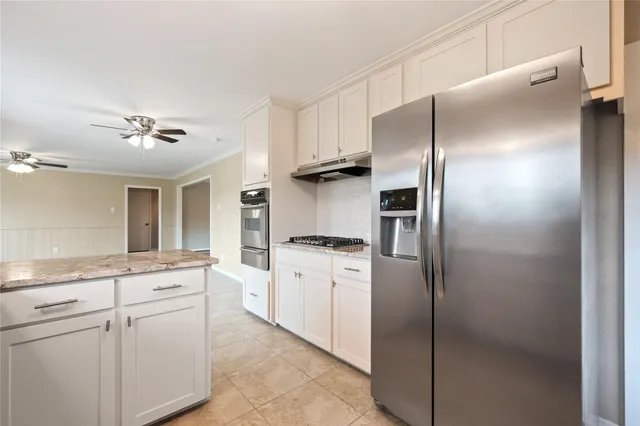 a kitchen with a refrigerator and a sink