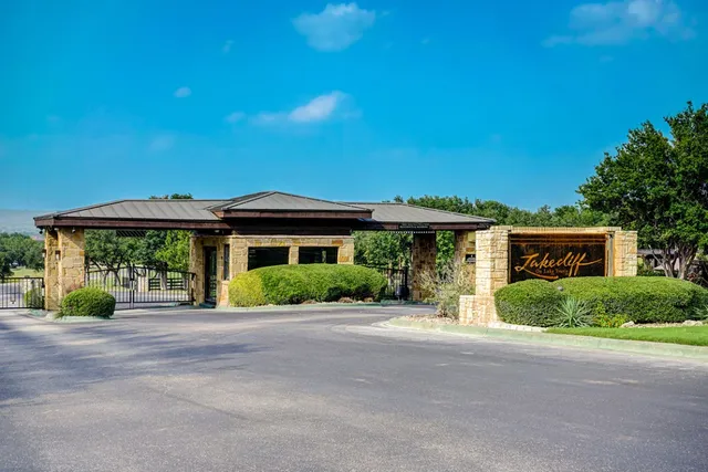 a front view of a house with a yard and potted plants