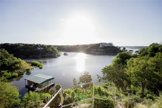 an aerial view of lake and residential houses with outdoor space