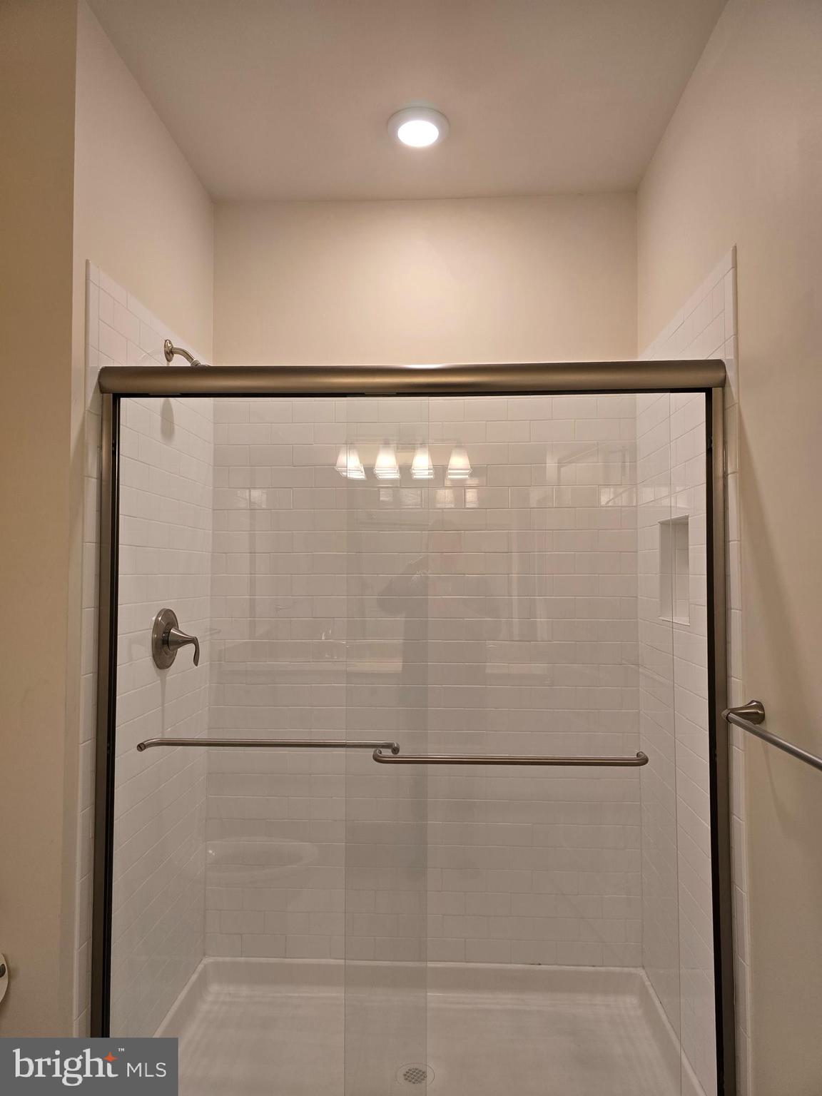 10530 Resort Road, Unit 101 Ellicott City, MD 21042 - Photo 10 of 13 a bathroom with a glass shower door