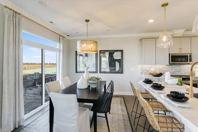 a view of a dining room with furniture a chandelier and wooden floor
