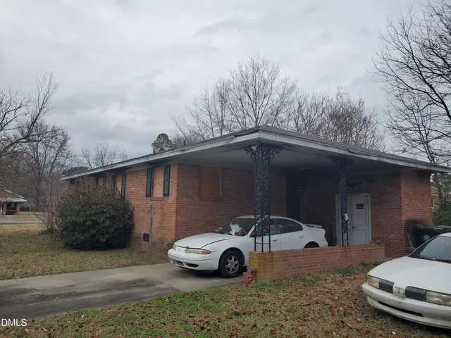 a car parked in the parking lot of a house