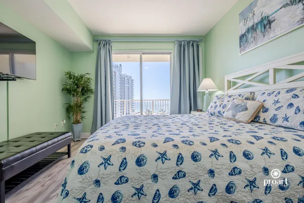 a bedroom with a large bed and a window