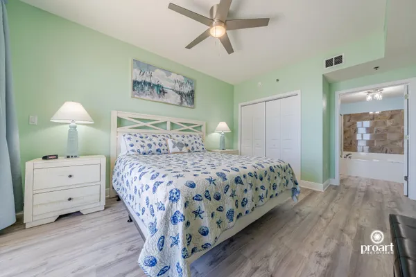 a bedroom with a bed and a chandelier