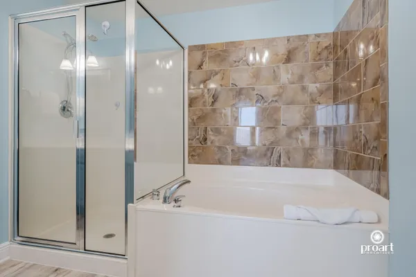 a bathroom with a bathtub and shower