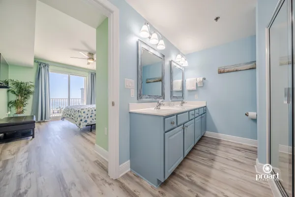 a bathroom with a sink a mirror and a shower