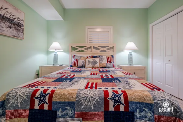 a bedroom with a bed and a chandelier