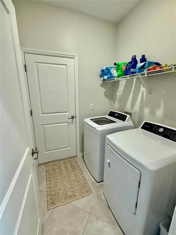 10852 Sun Drop Street Venice, FL 34293 - Photo 14 of 15 a utility room with dryer and washer