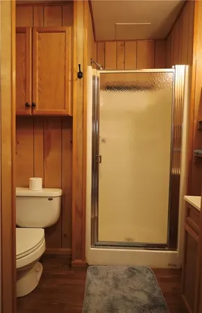 a bathroom with a toilet and a shower