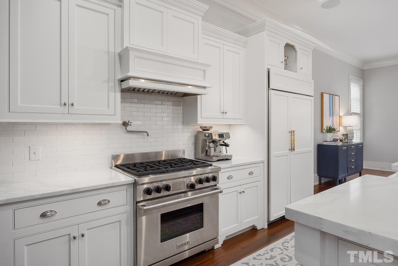 2908 Allansford Lane Raleigh, NC 27613 - Photo 13 of 64 a kitchen with stainless steel appliances white cabinets and a stove