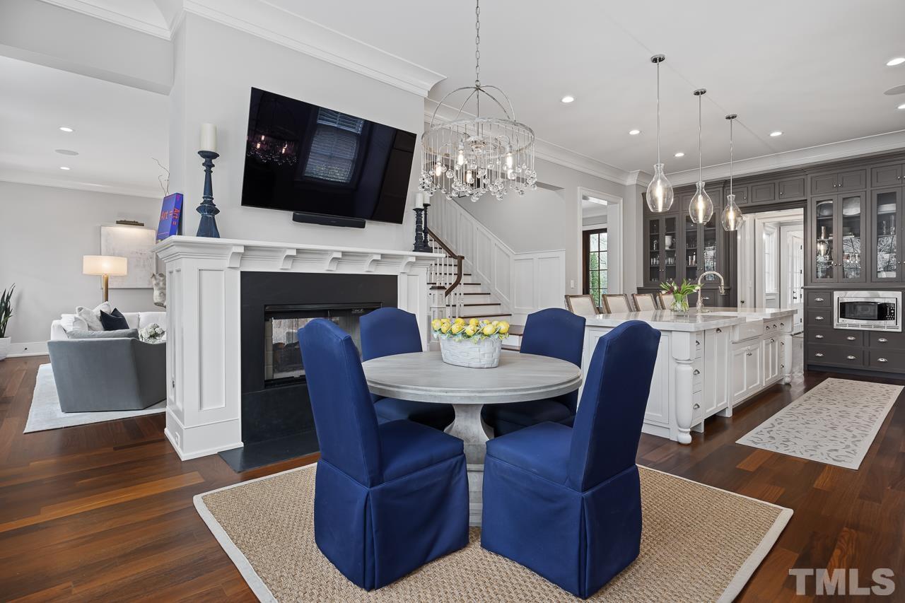 2908 Allansford Lane Raleigh, NC 27613 - Photo 19 of 64 a living room with furniture a fireplace and a flat screen tv