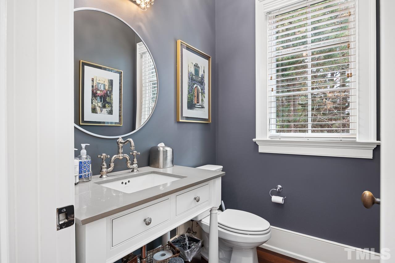 2908 Allansford Lane Raleigh, NC 27613 - Photo 20 of 64 a bathroom with a toilet a sink and mirror