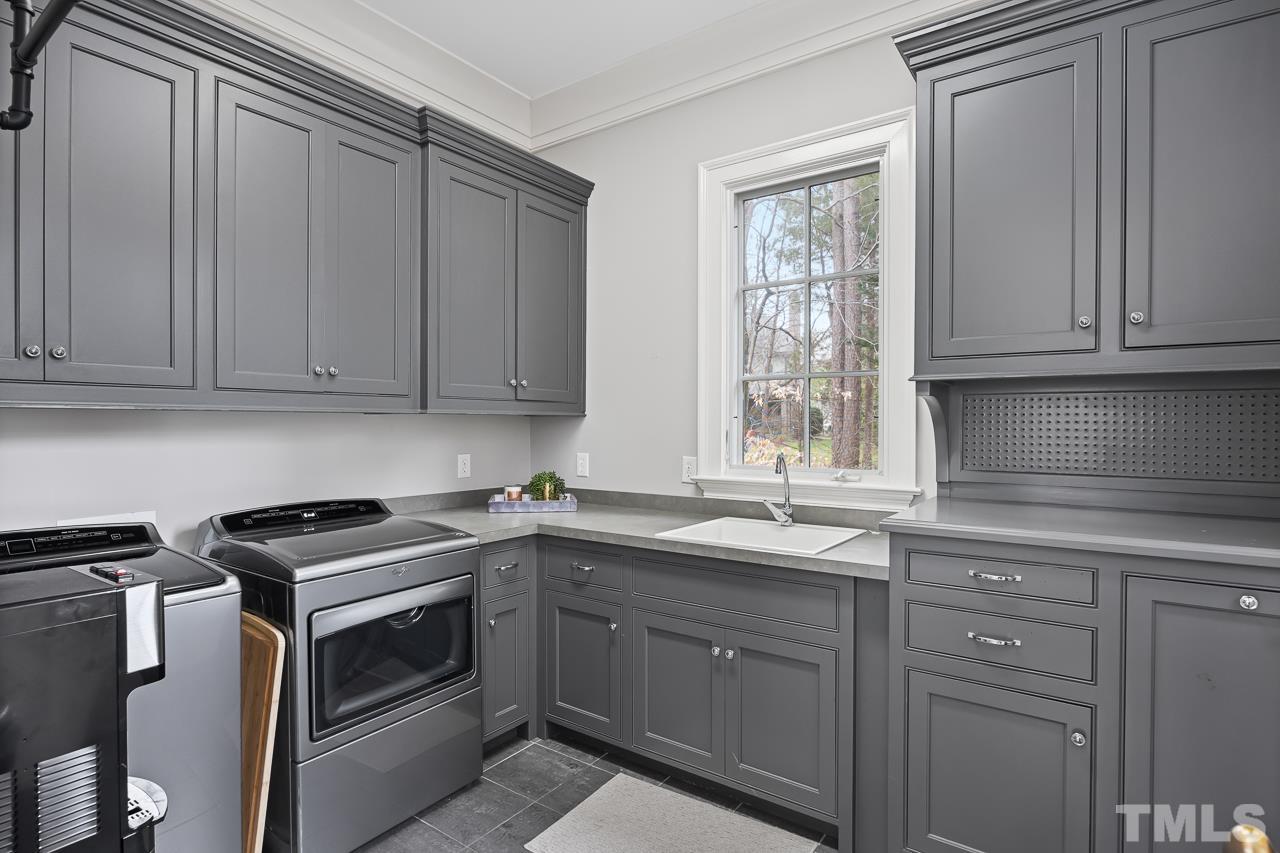 2908 Allansford Lane Raleigh, NC 27613 - Photo 23 of 64 a kitchen with a sink stove and cabinets
