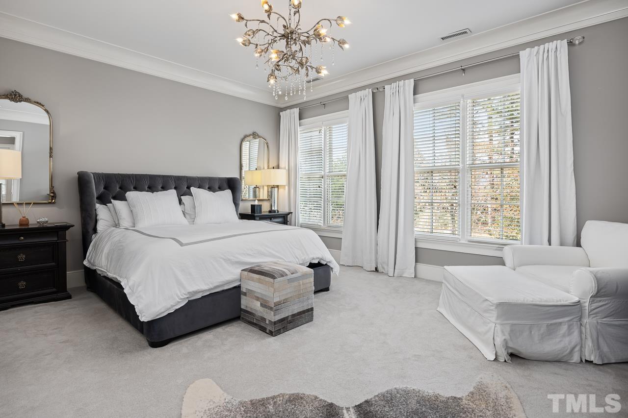 2908 Allansford Lane Raleigh, NC 27613 - Photo 29 of 64 a spacious bedroom with a bed and a couch