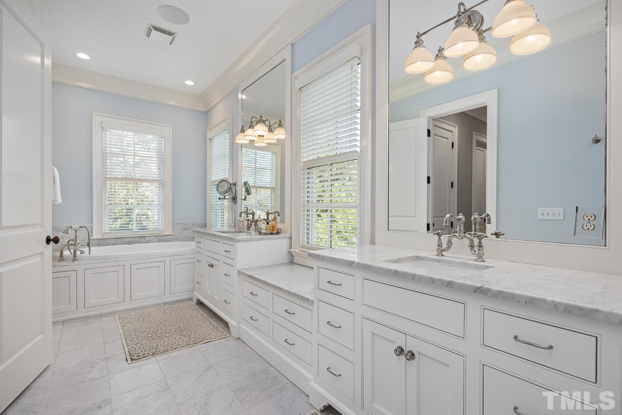 2908 Allansford Lane Raleigh, NC 27613 - Photo 31 of 64 a bathroom with a granite countertop sink mirror and a bathtub