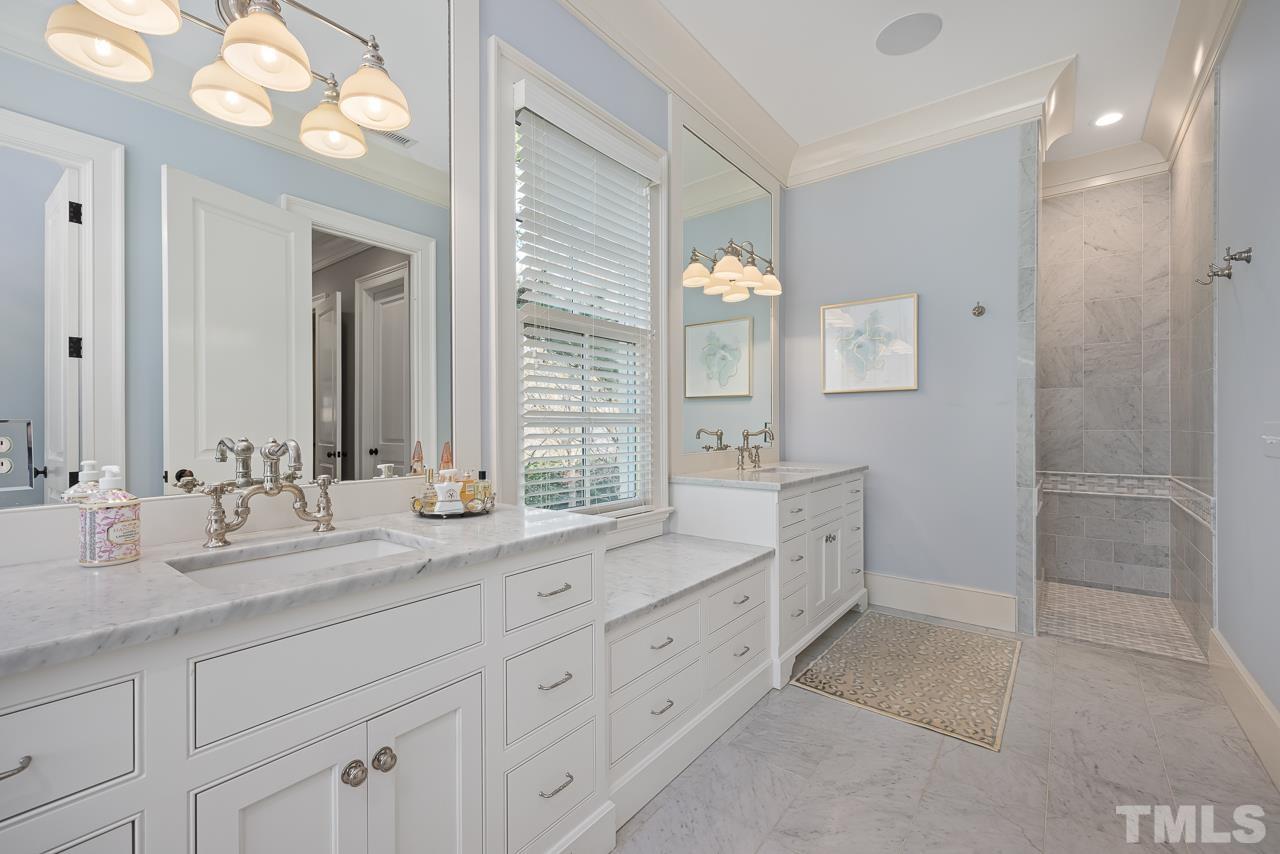 2908 Allansford Lane Raleigh, NC 27613 - Photo 33 of 64 a spacious bathroom with double sink a mirror a window and a shower