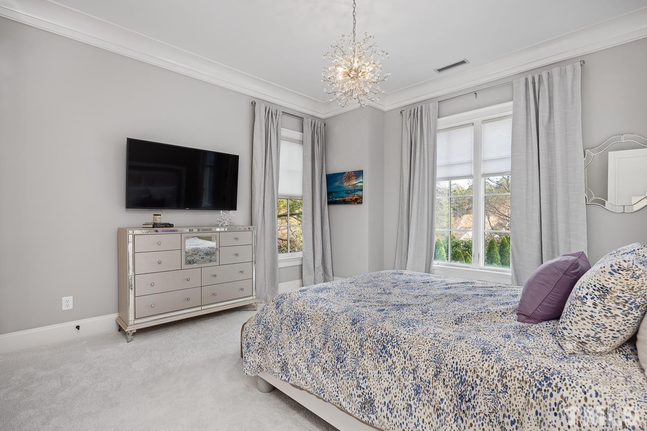 2908 Allansford Lane Raleigh, NC 27613 - Photo 37 of 64 a bedroom with a large bed and flat tv