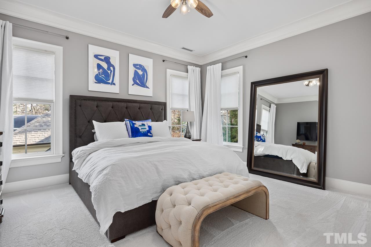 2908 Allansford Lane Raleigh, NC 27613 - Photo 41 of 64 a bedroom with a bed and a large mirror