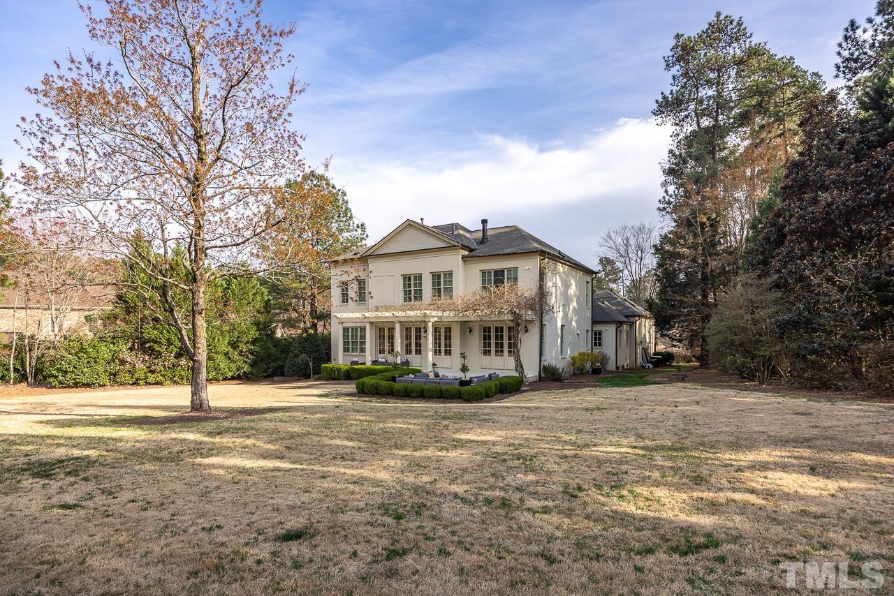 2908 Allansford Lane Raleigh, NC 27613 - Photo 51 of 64 a view of a white house with a big yard and large trees