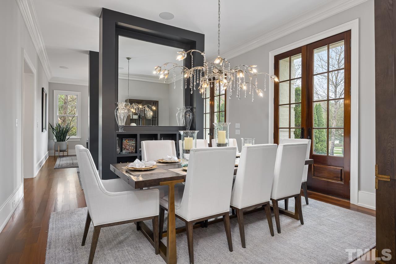 2908 Allansford Lane Raleigh, NC 27613 - Photo 6 of 64 a dining room with furniture a chandelier and a rug