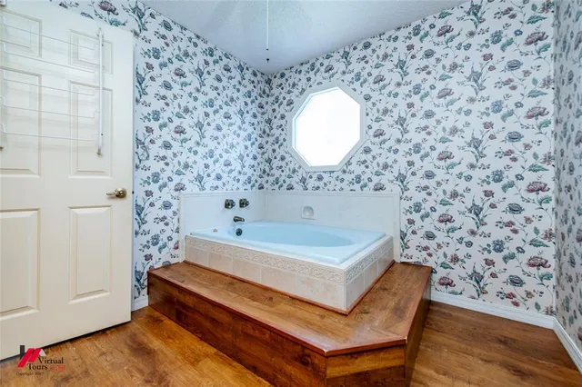 a bathroom with a bathtub and a shower