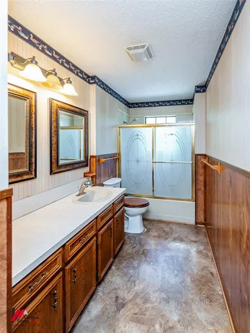a spacious bathroom with a double vanity sink mirror and toilet