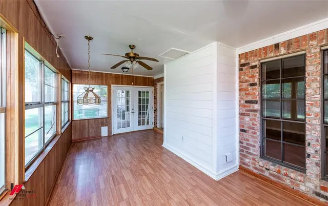 a view of an entryway with wooden floor and windows